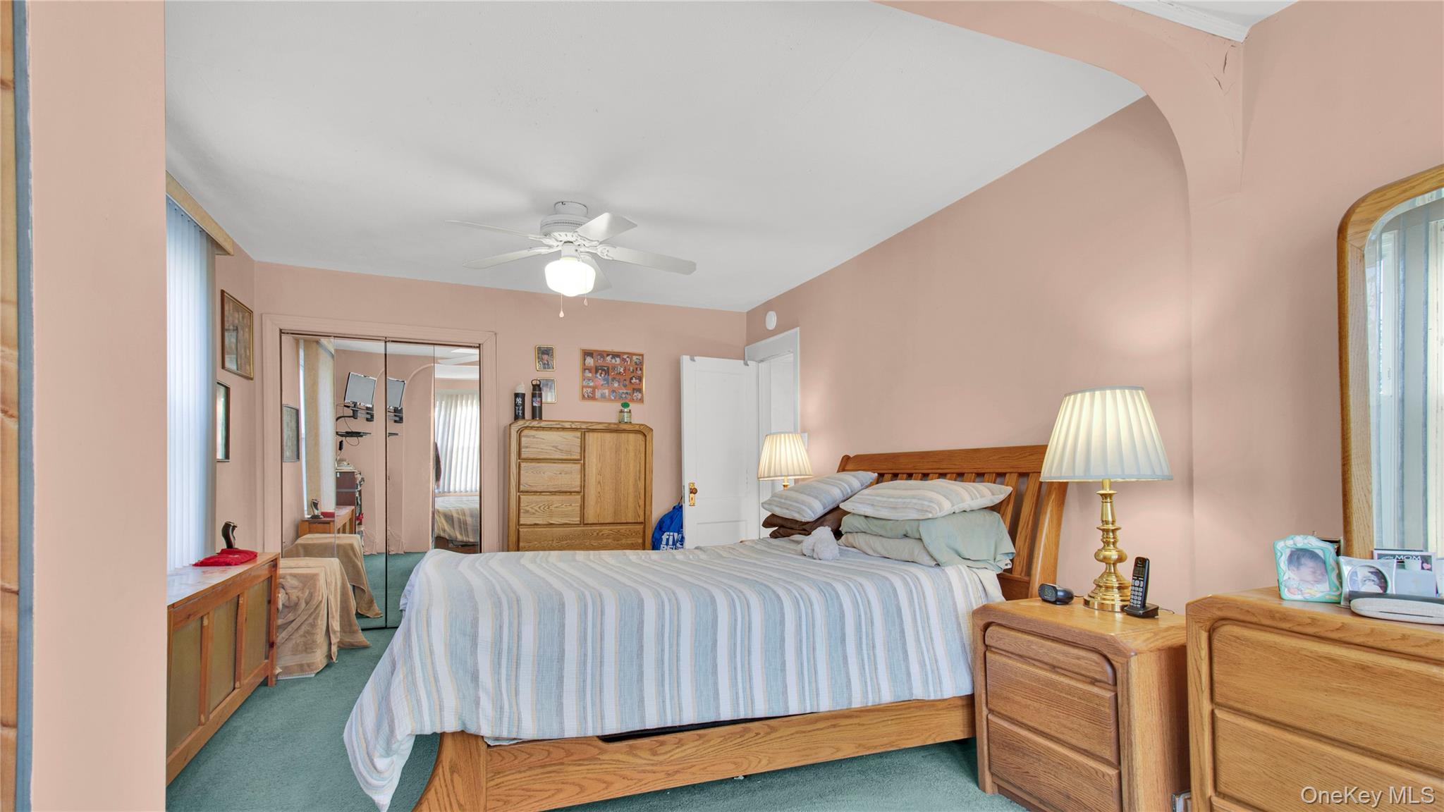 56 Liggett Road Valley Stream, NY 11581 - Photo 23 of 29 a bedroom with a bed and a chandelier
