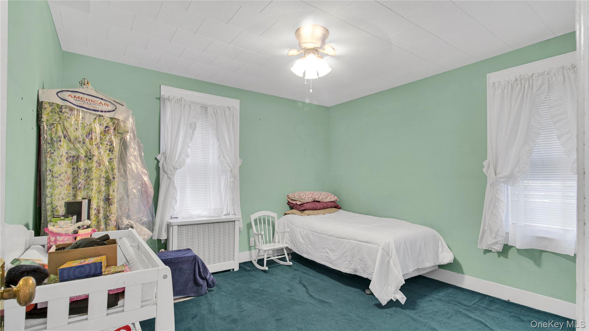56 Liggett Road Valley Stream, NY 11581 - Photo 24 of 29 a bedroom with a bed table and window