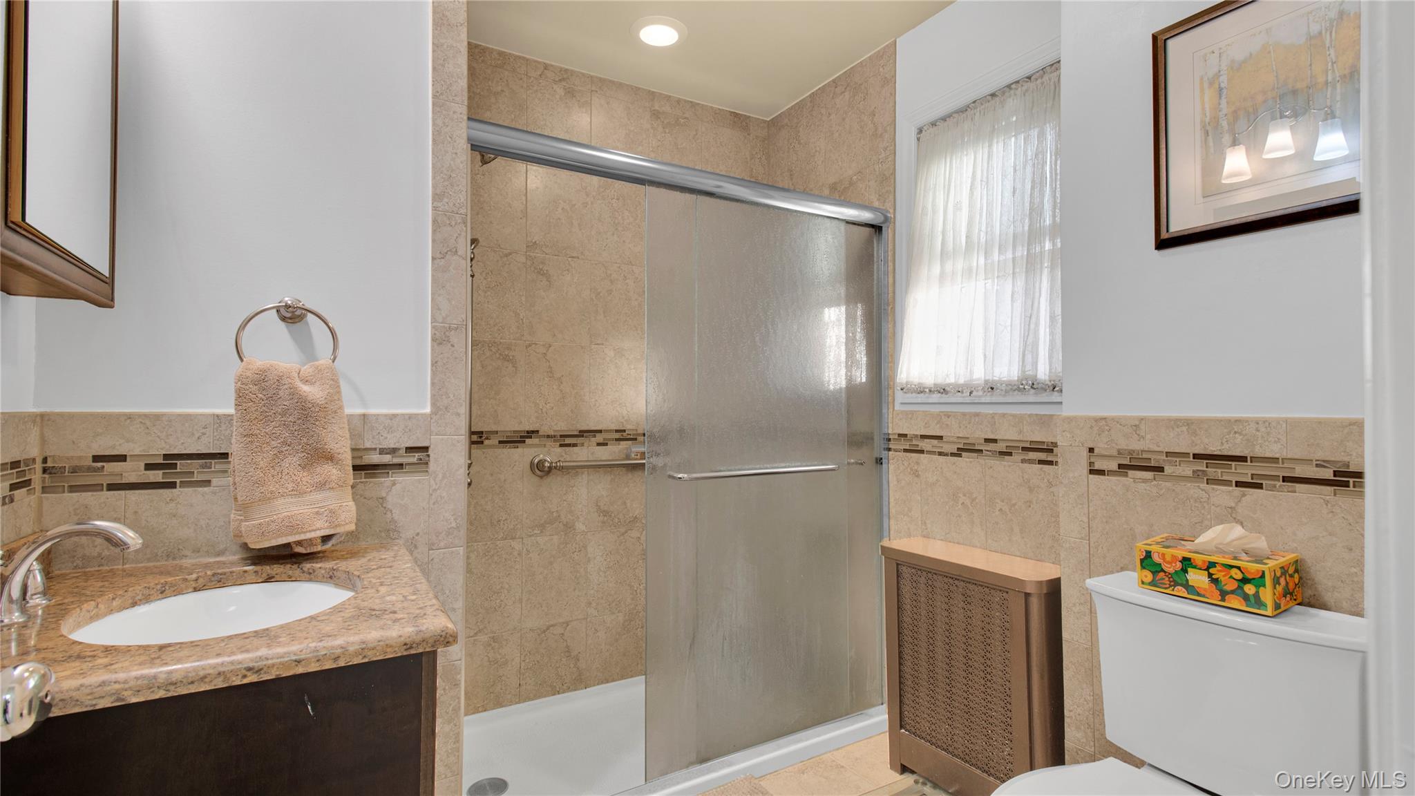 56 Liggett Road Valley Stream, NY 11581 - Photo 25 of 29 a bathroom with a sink double vanity and a mirror