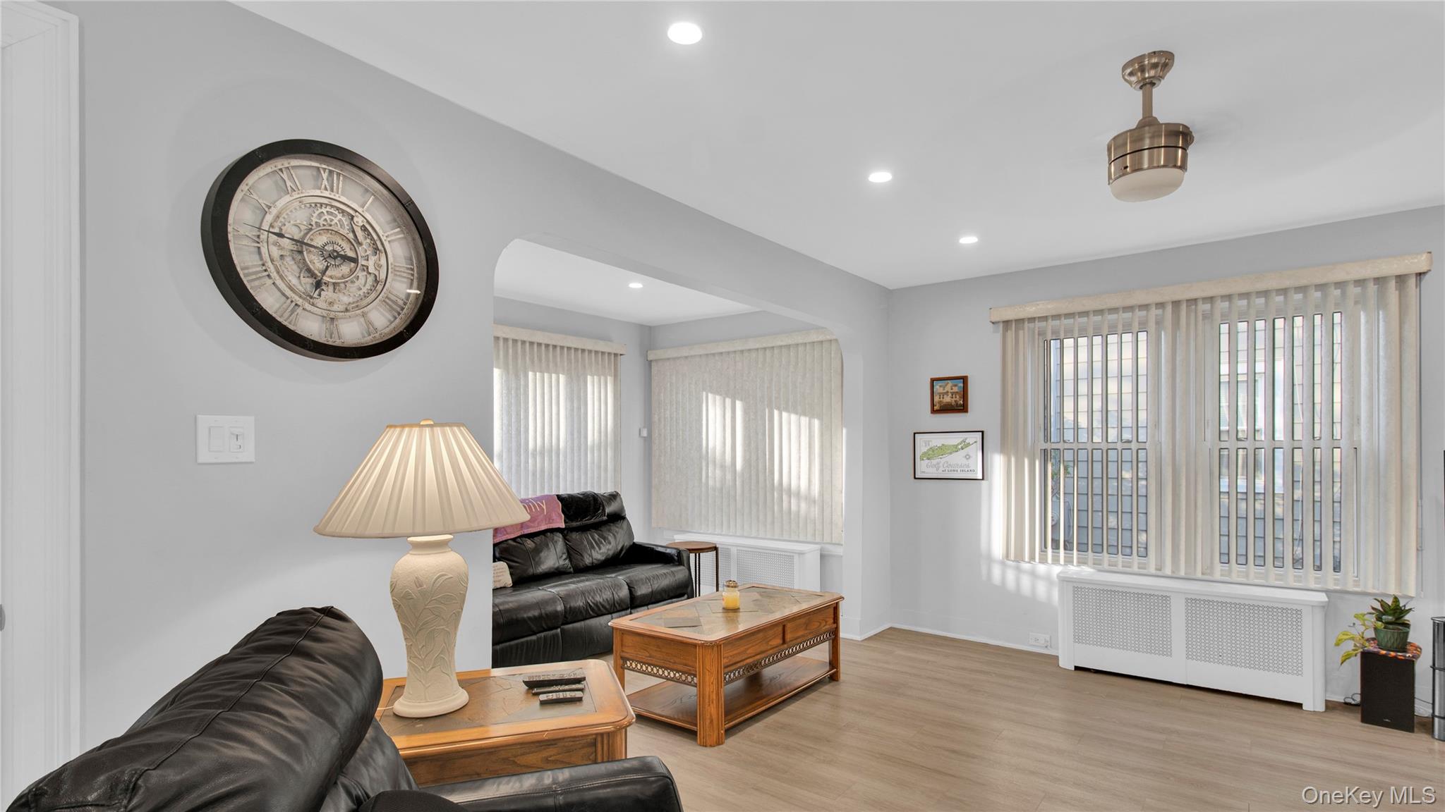 56 Liggett Road Valley Stream, NY 11581 - Photo 9 of 29 a living room with furniture and a chandelier