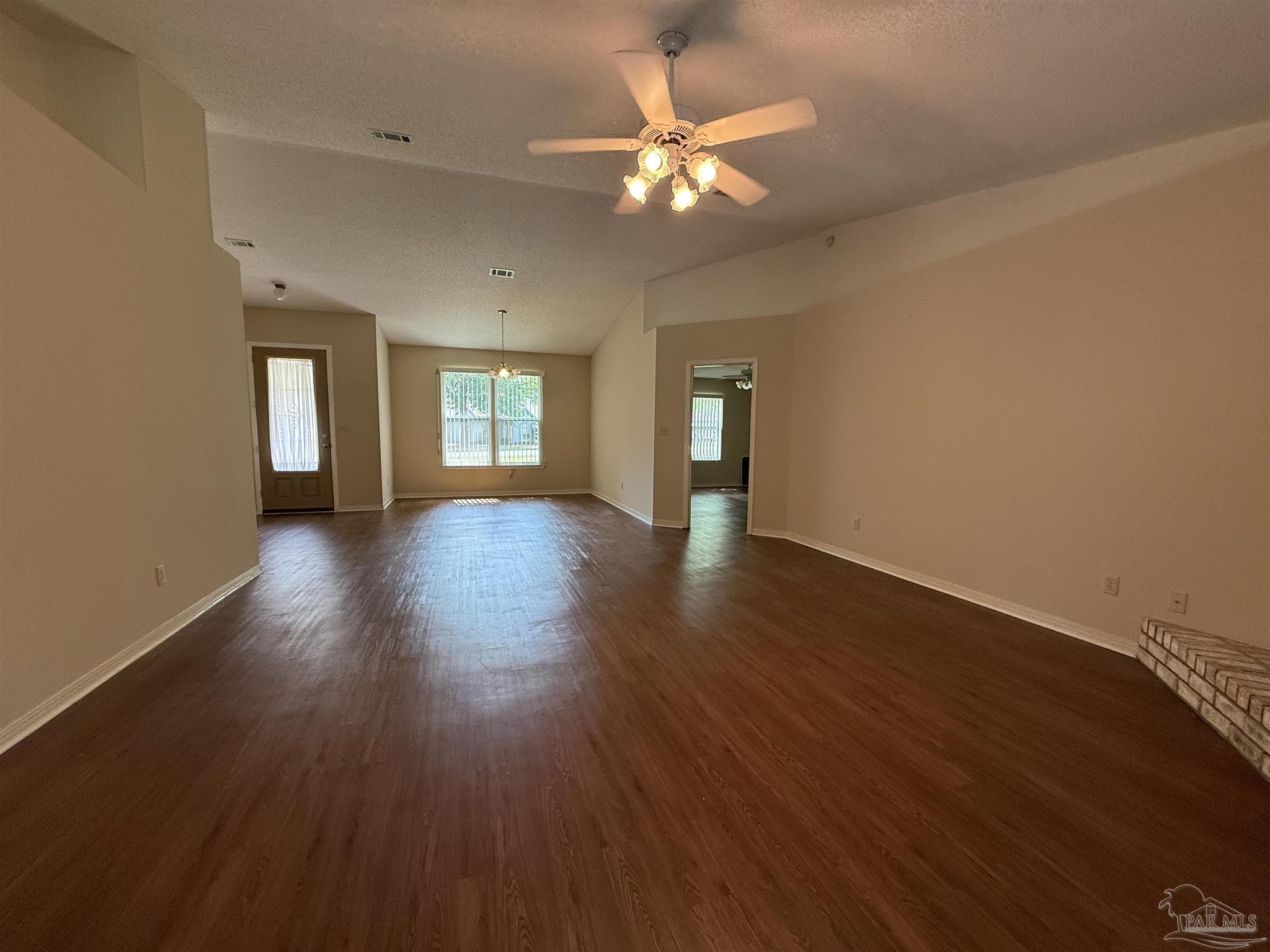 4814 Autumn Drive Pace, FL 32571 - Photo 11 of 52 a view of a room with wooden floor and a ceiling fan