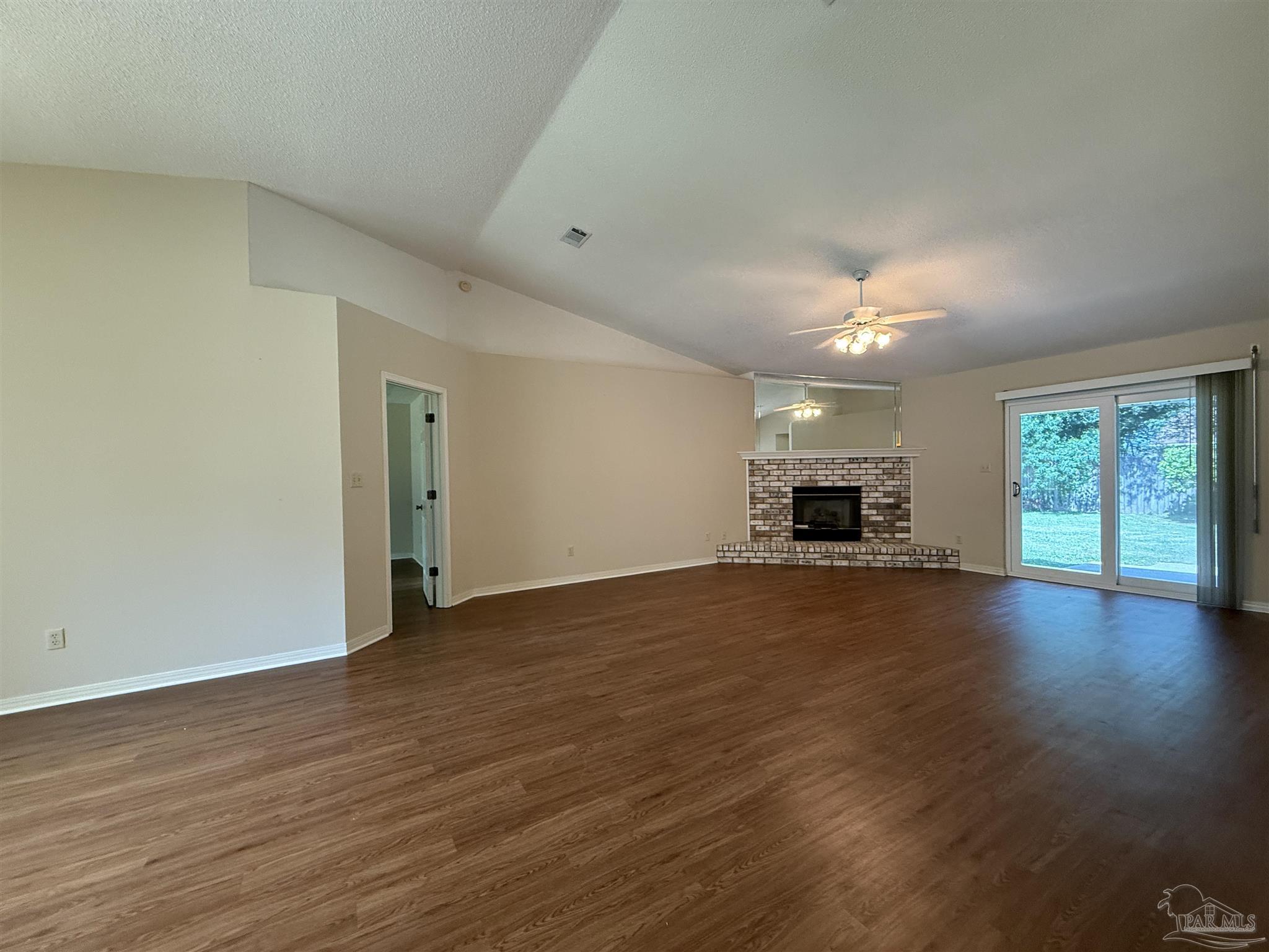 4814 Autumn Drive Pace, FL 32571 - Photo 13 of 52 a view of empty room with wooden floor and window
