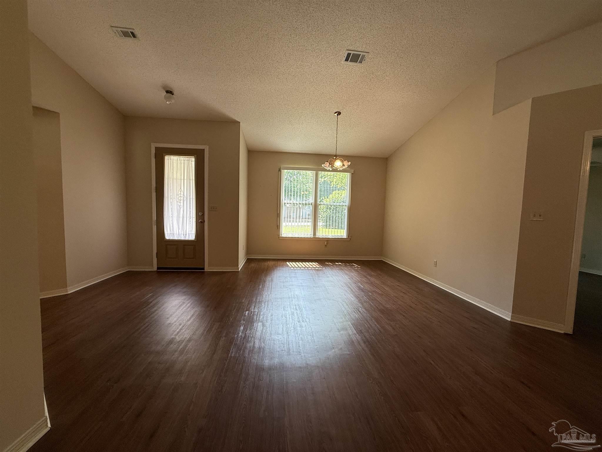 4814 Autumn Drive Pace, FL 32571 - Photo 15 of 52 a view of an empty room with wooden floor and window