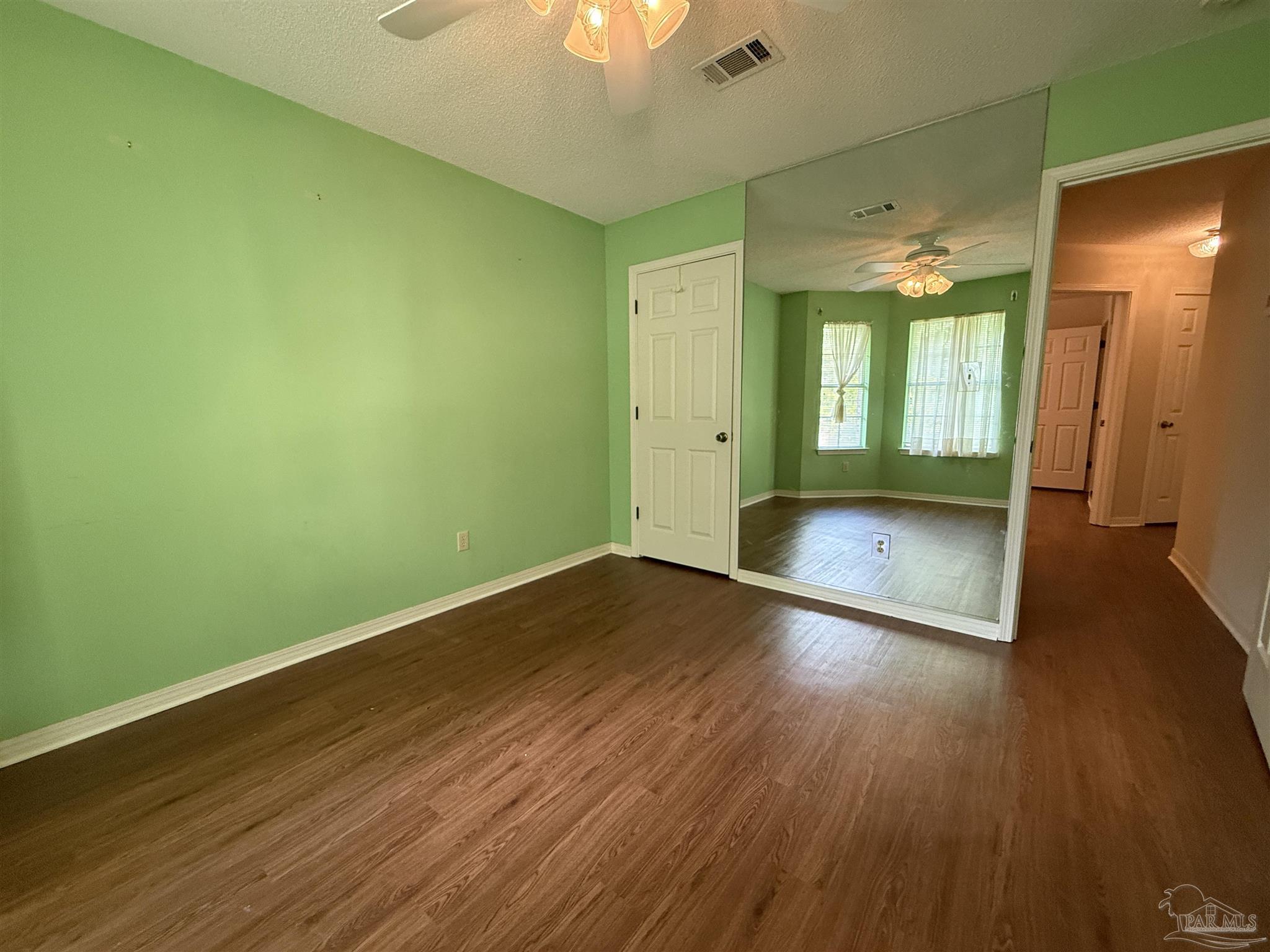 4814 Autumn Drive Pace, FL 32571 - Photo 29 of 52 a view of wooden floor and windows in a room