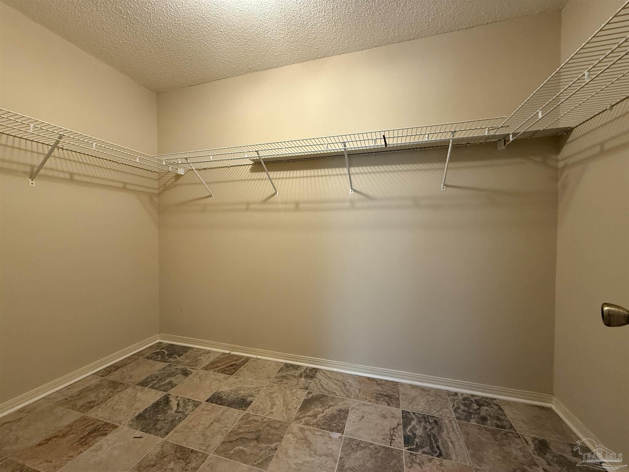 4814 Autumn Drive Pace, FL 32571 - Photo 33 of 52 a view of a room with racks on the wall