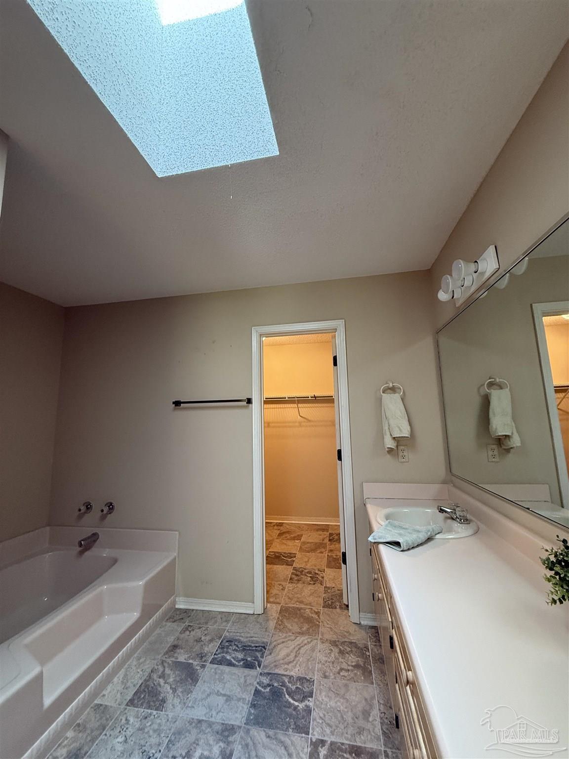 4814 Autumn Drive Pace, FL 32571 - Photo 36 of 52 a bathroom with a tub sink and mirror