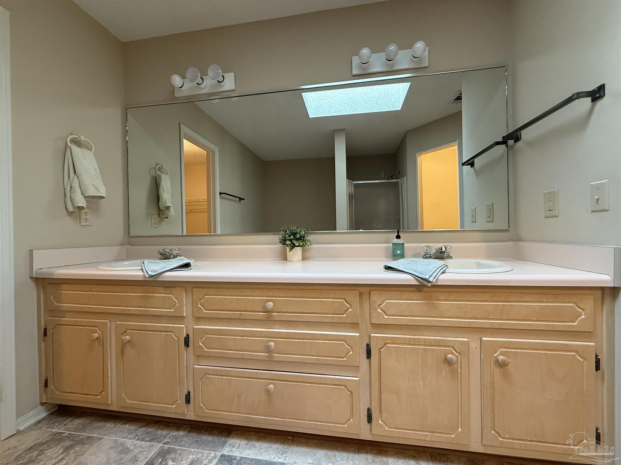 4814 Autumn Drive Pace, FL 32571 - Photo 38 of 52 a spacious bathroom with a double vanity sink and a mirror