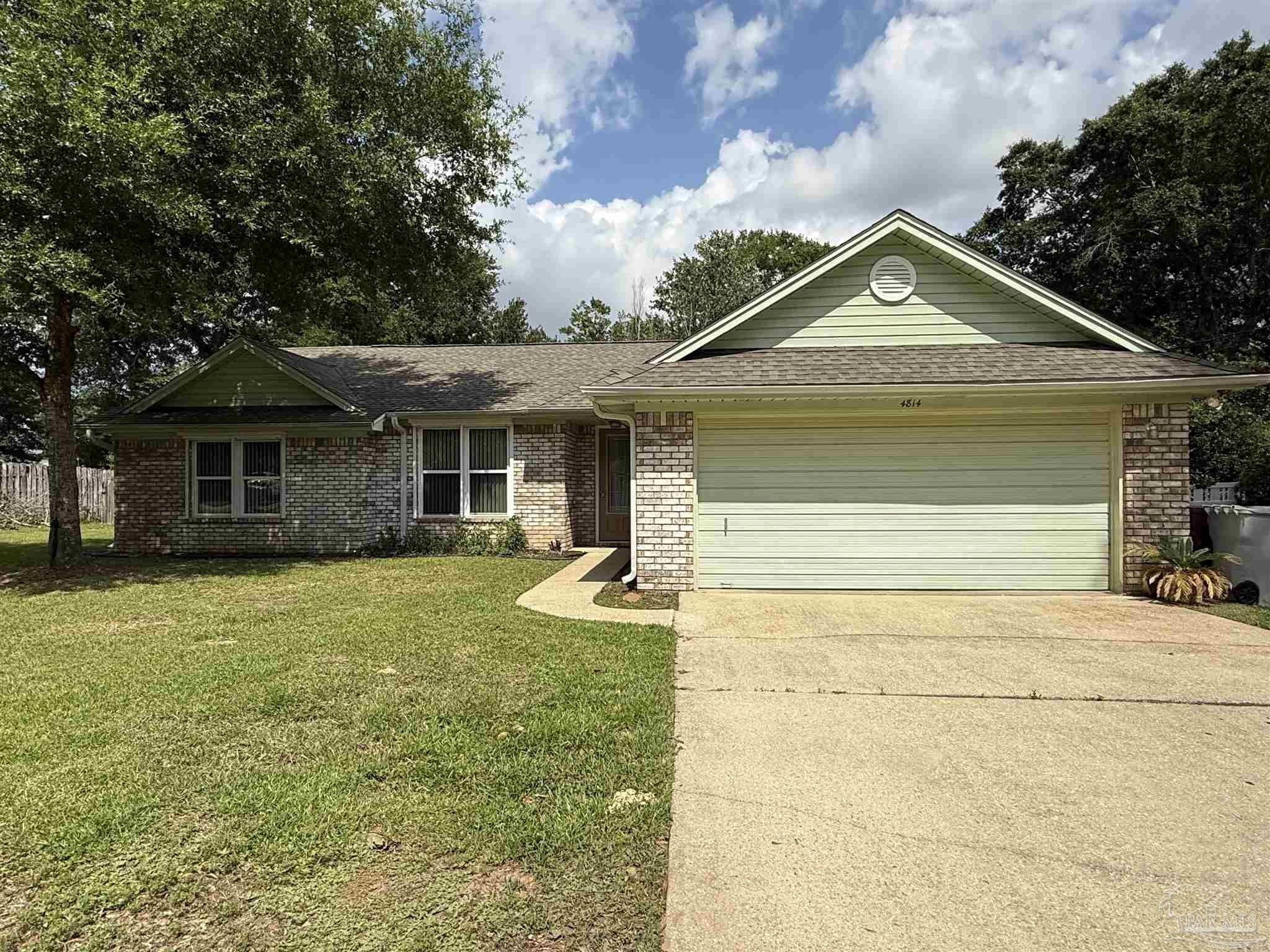 4814 Autumn Drive Pace, FL 32571 - Photo 45 of 52 a front view of a house with a garden and trees