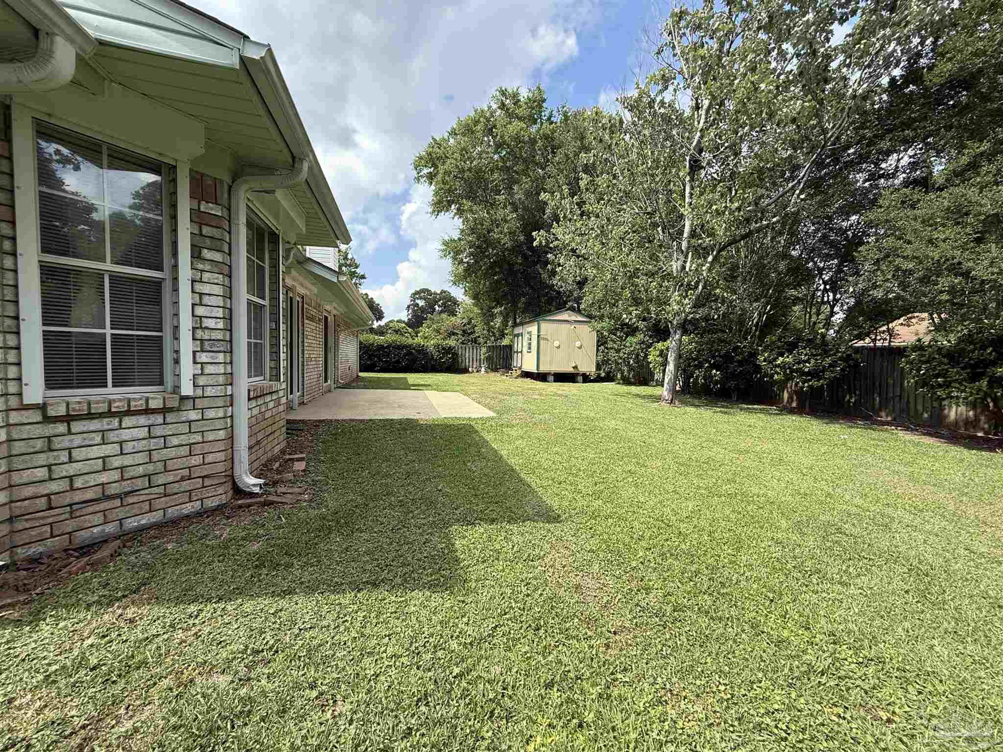 4814 Autumn Drive Pace, FL 32571 - Photo 52 of 52 a view of a house with backyard and garden