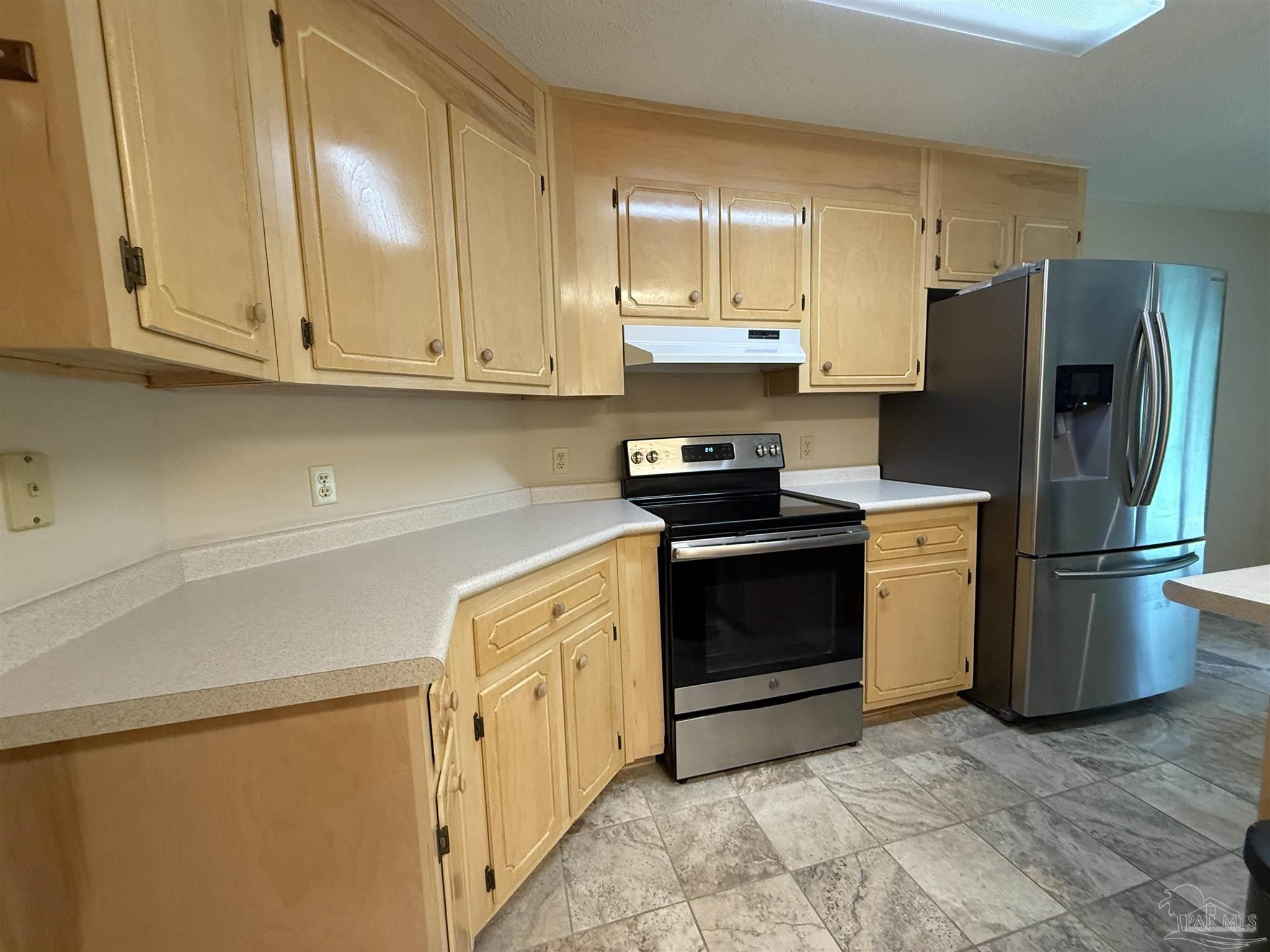 4814 Autumn Drive Pace, FL 32571 - Photo 9 of 52 a kitchen with stainless steel appliances granite countertop a refrigerator sink and stove