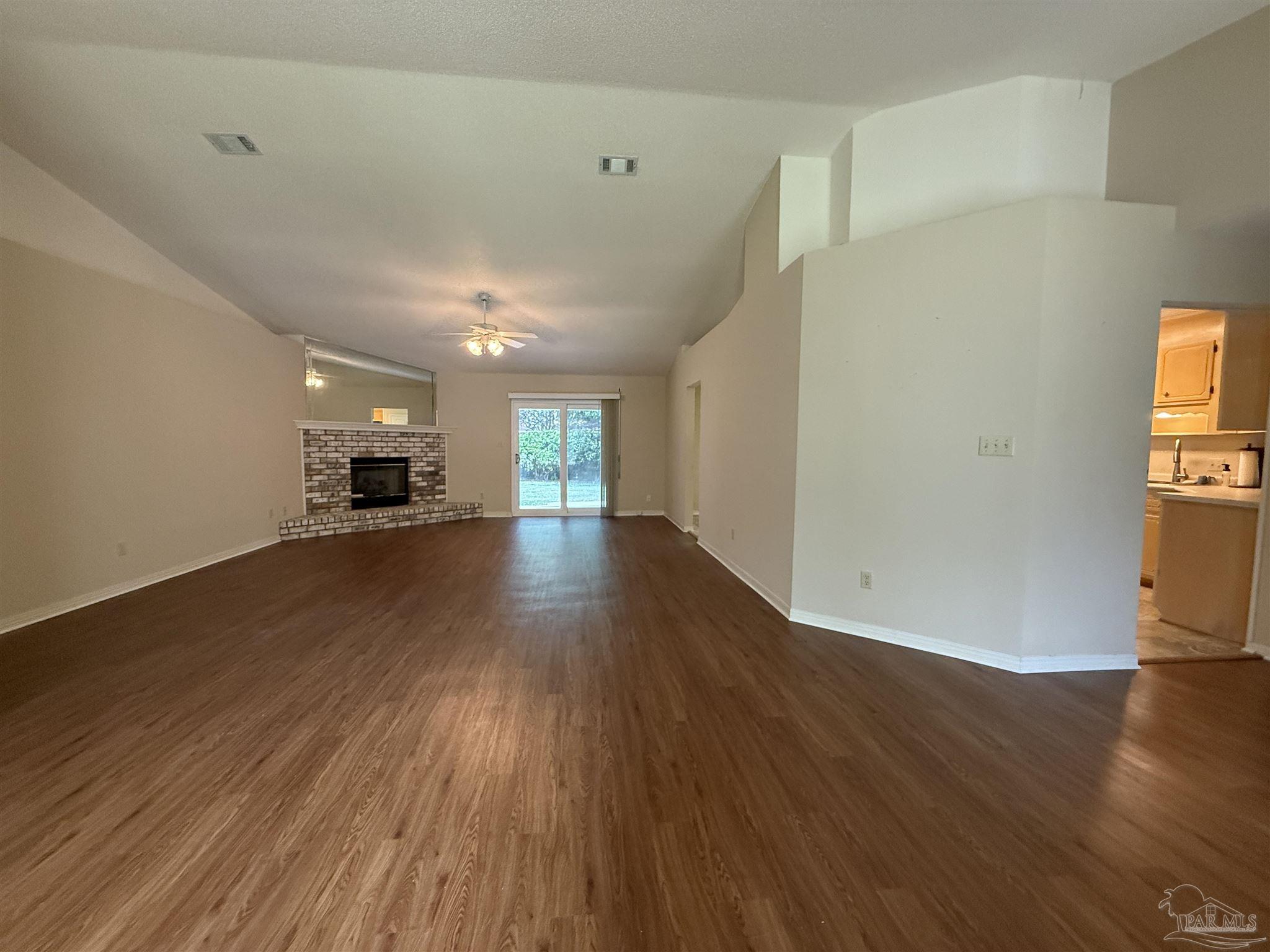 4814 Autumn Drive Pace, FL 32571 - Photo 10 of 52 a view of empty room with wooden floor