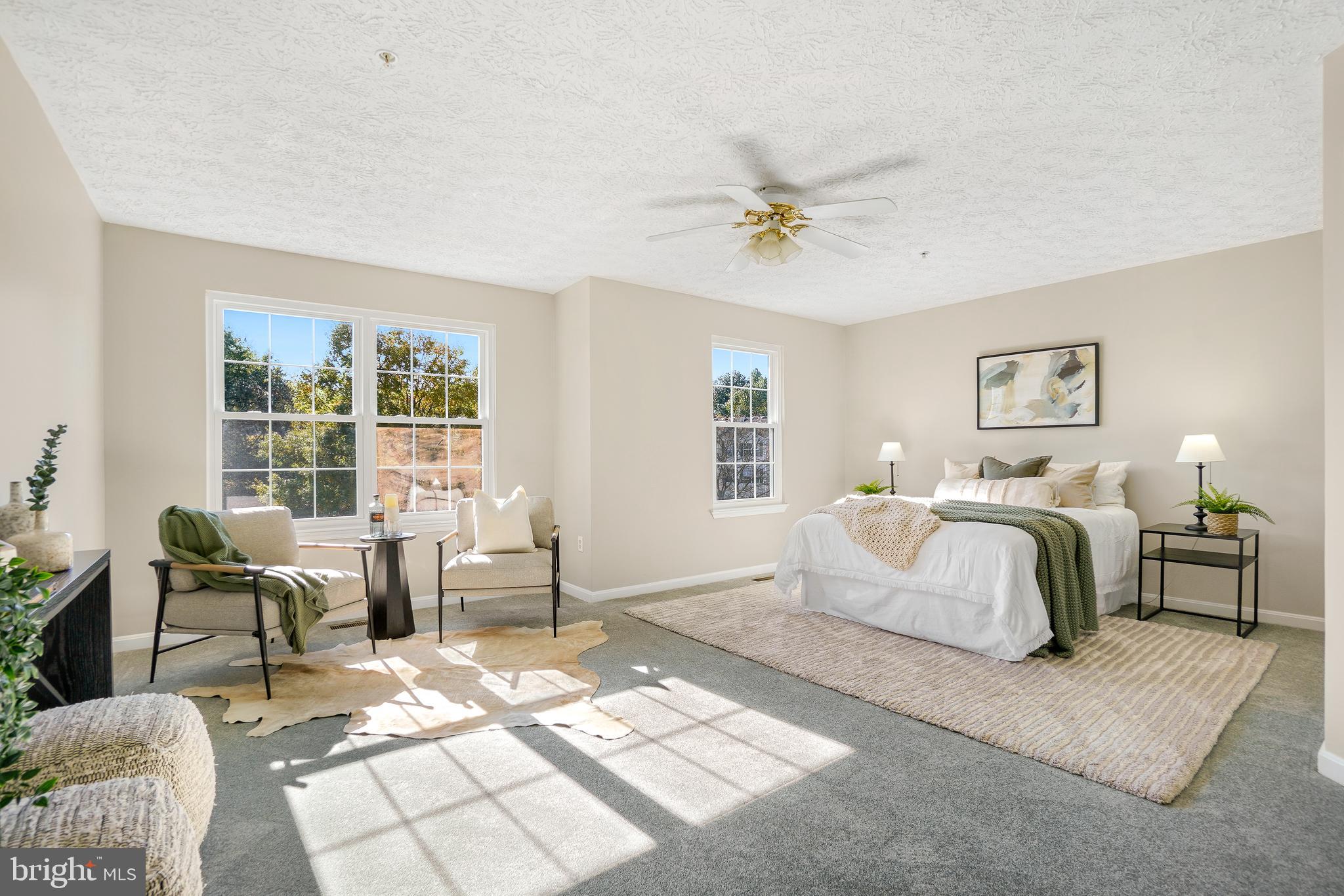10 Ironstone Court, Unit E Annapolis, MD 21403 - Photo 19 of 24 a spacious bedroom with a bed a couch and a window