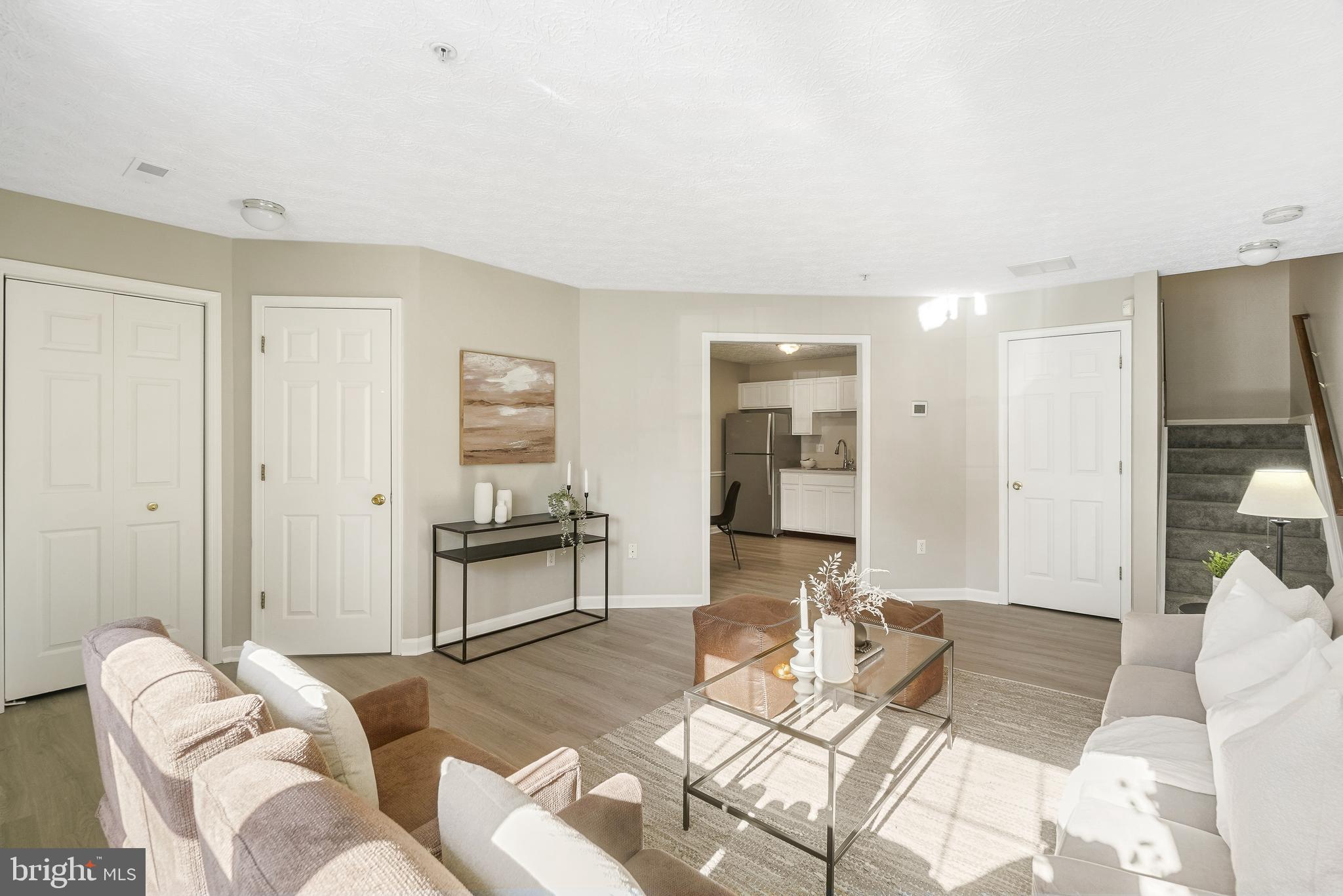 10 Ironstone Court, Unit E Annapolis, MD 21403 - Photo 5 of 24 a living room with furniture or couch and a dining table