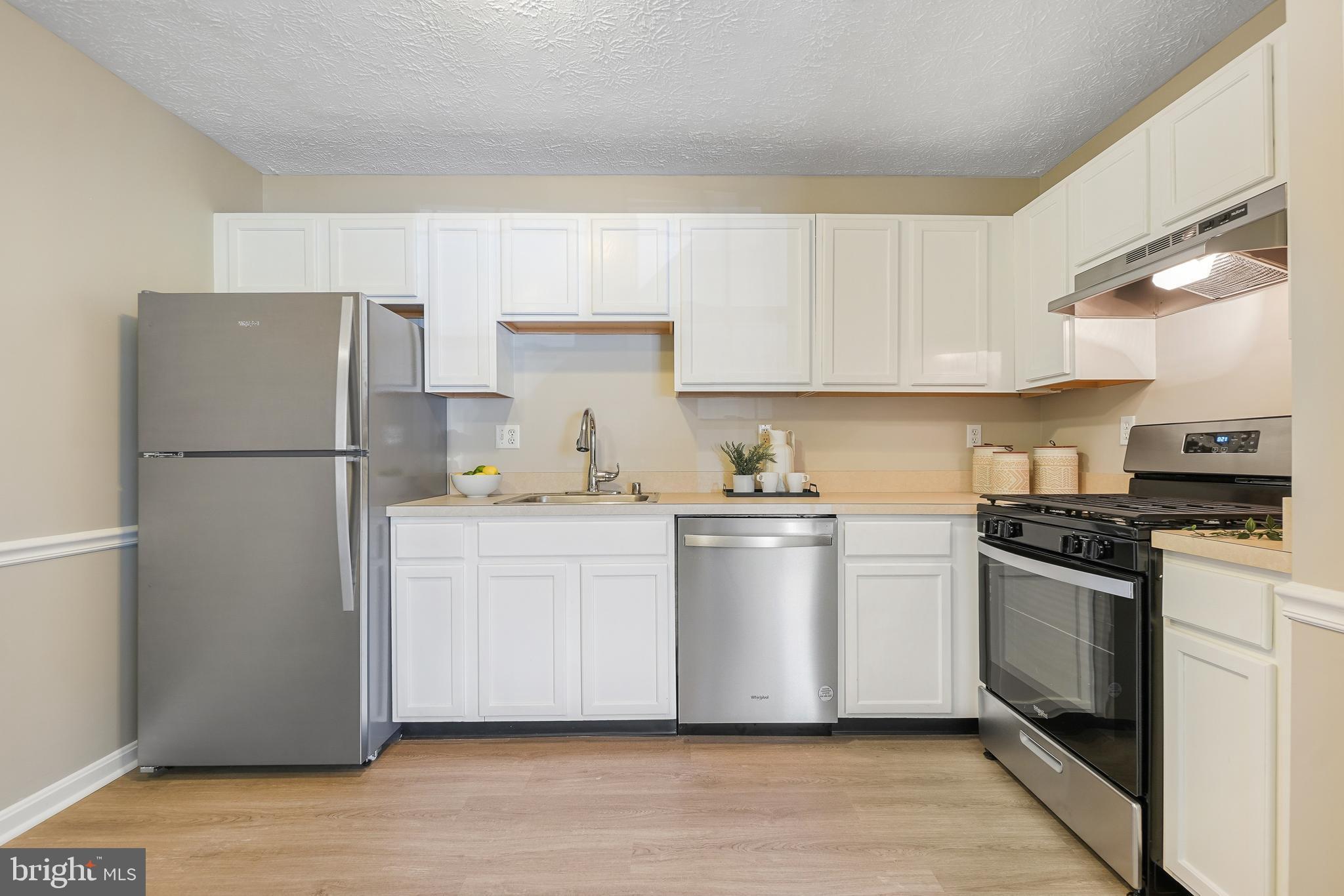 10 Ironstone Court, Unit E Annapolis, MD 21403 - Photo 8 of 24 a kitchen with stainless steel appliances granite countertop a refrigerator stove a sink and a granite counter tops