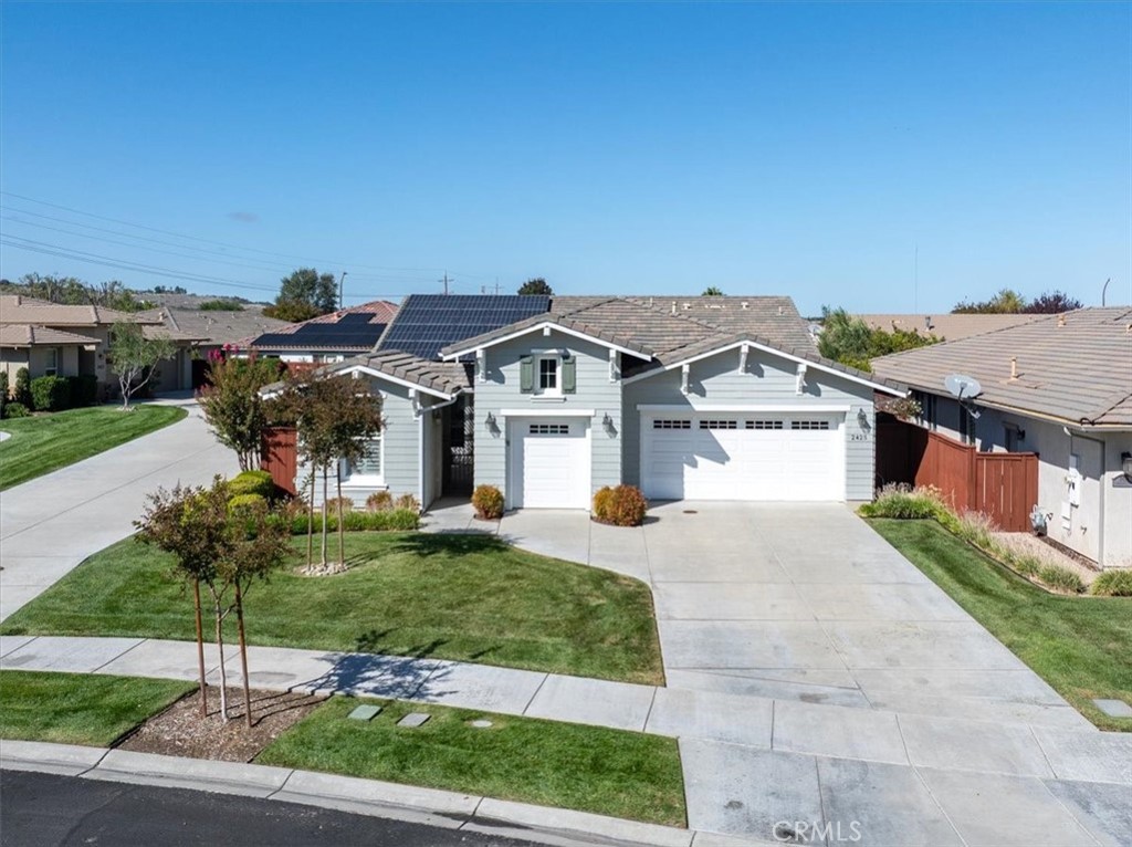 a front view of house with yard and green space