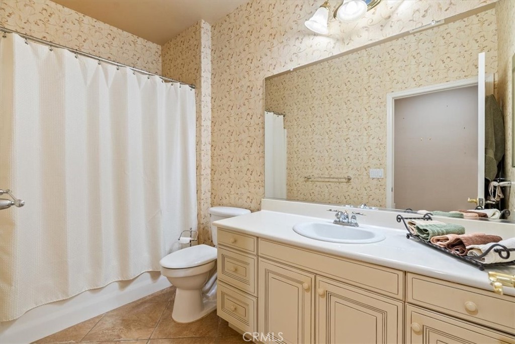 2425 Traditions Loop Paso Robles, CA 93446 - Photo 25 of 34 a bathroom with a double vanity sink toilet and a mirror