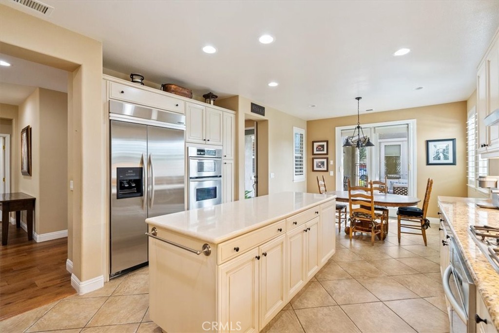 2425 Traditions Loop Paso Robles, CA 93446 - Photo 9 of 34 a large white kitchen with a large window and stainless steel appliances