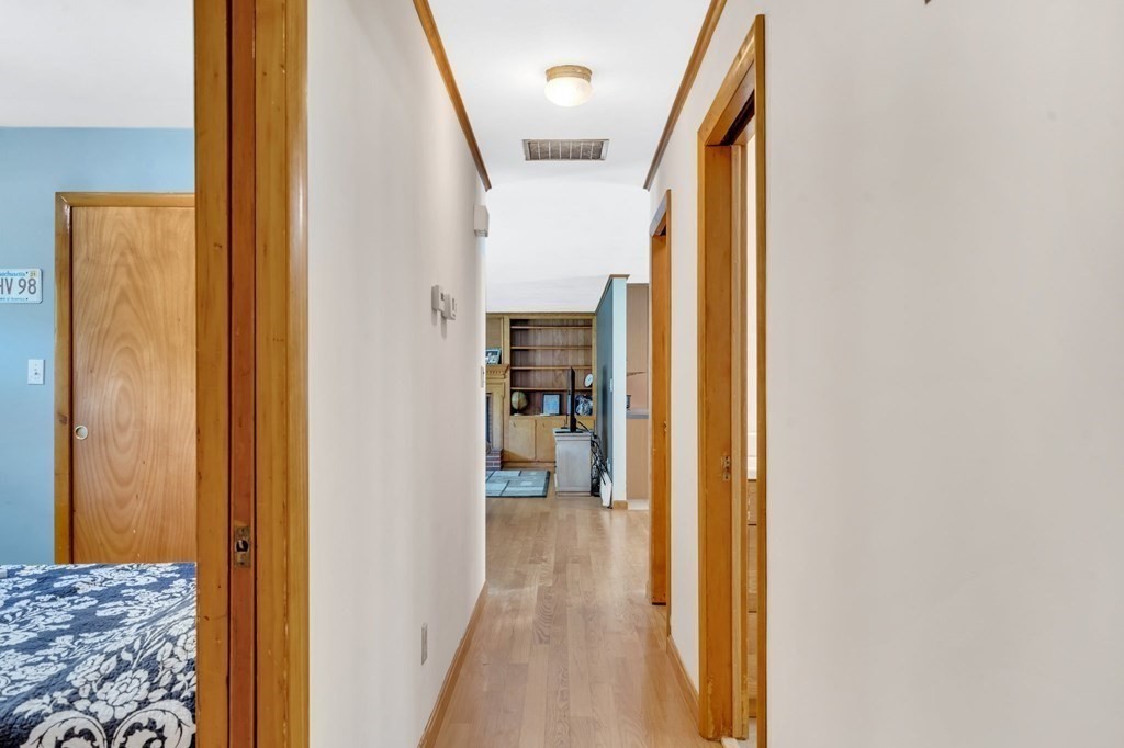 91 Lower Gore Road Webster, MA 01570 - Photo 12 of 37 a view of a hallway with wooden floor and a bathroom