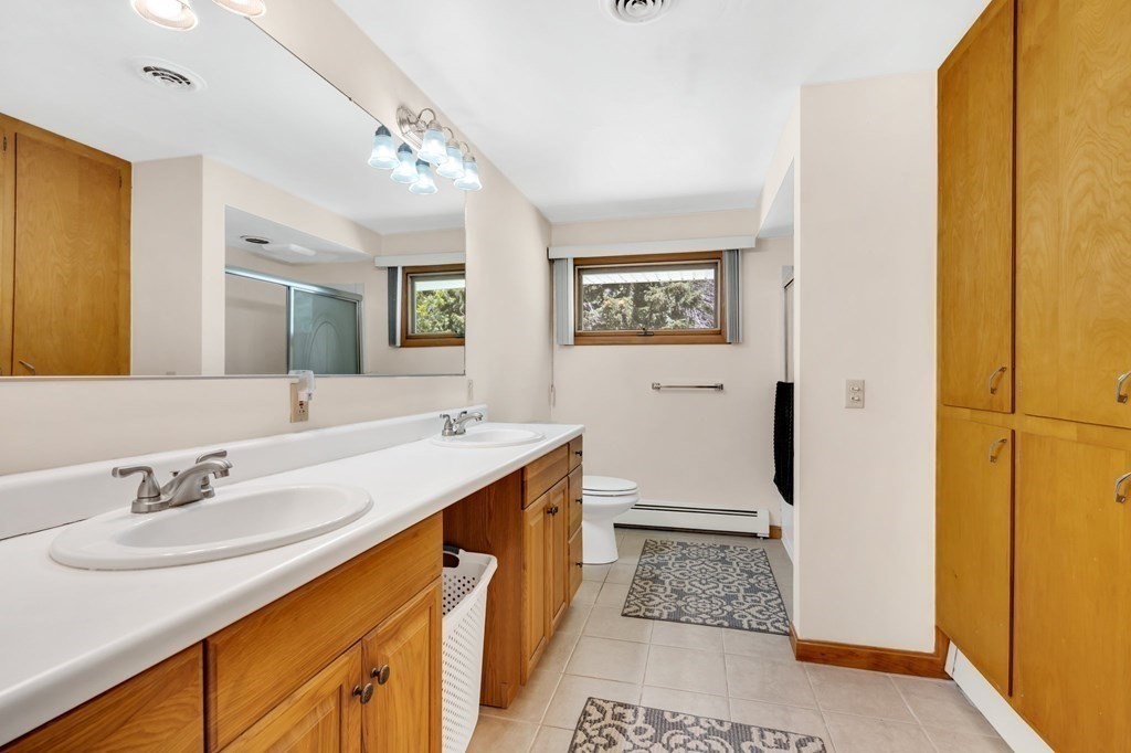 91 Lower Gore Road Webster, MA 01570 - Photo 13 of 37 a bathroom with a sink a mirror and a shower