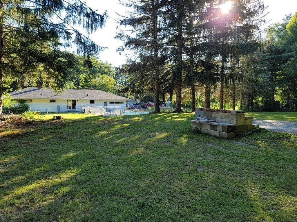 91 Lower Gore Road Webster, MA 01570 - Photo 34 of 37 a swimming pool is sitting in the grass near a house