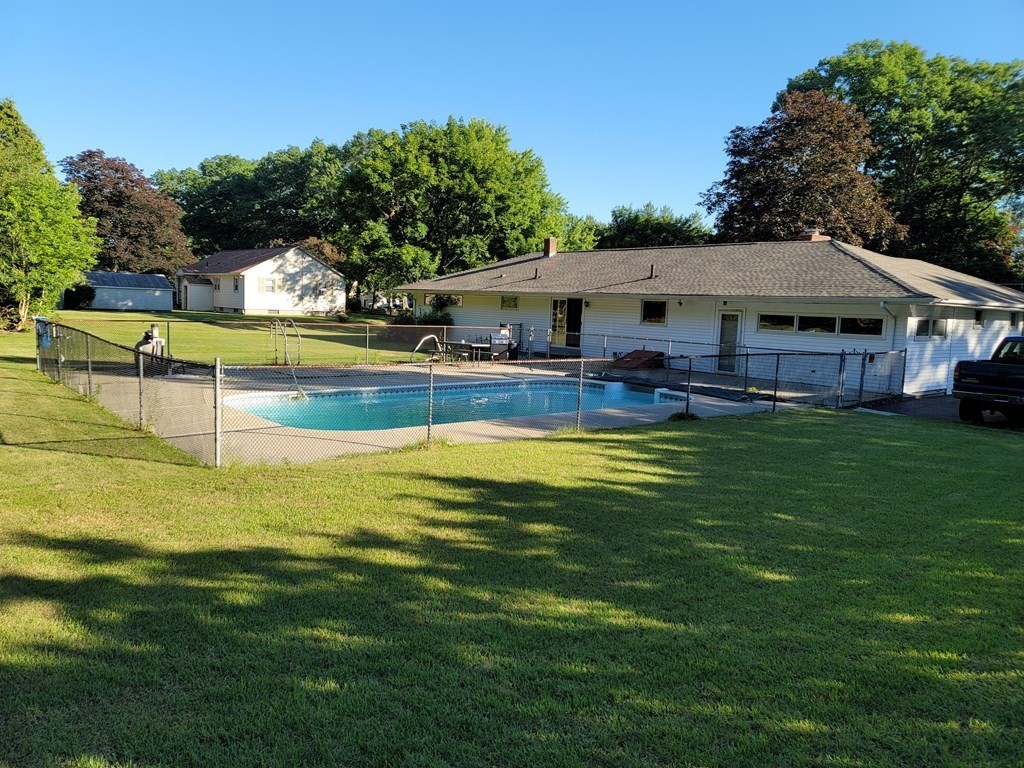 91 Lower Gore Road Webster, MA 01570 - Photo 7 of 37 a view of swimming pool with lawn chairs and plants