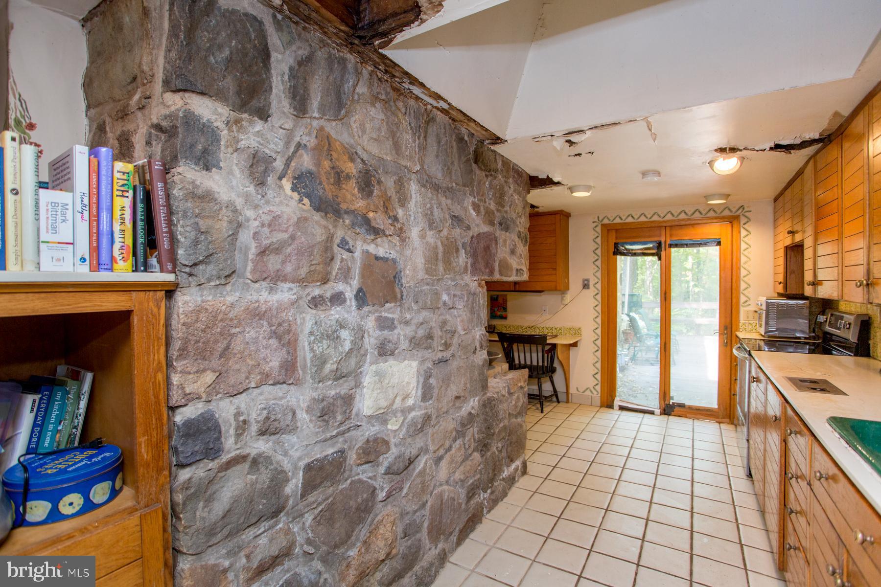 5131 Toll Gate Road Pipersville, PA 18947 - Photo 12 of 53 Kitchen stone wall & book shelves