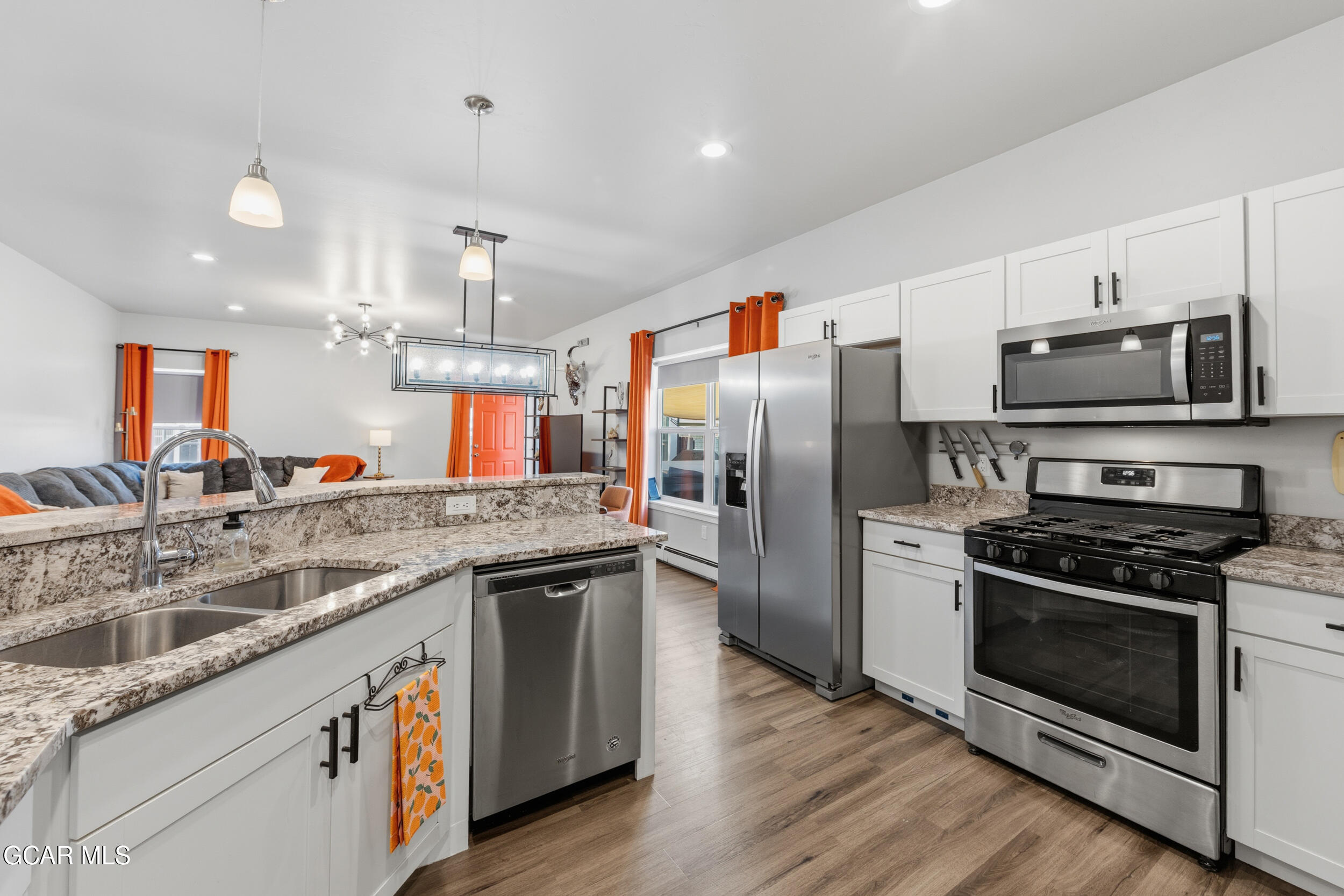 503 12th Street, Unit B Kremmling, CO 80459 - Photo 2 of 44 a kitchen with stainless steel appliances granite countertop a stove top oven a refrigerator and a sink