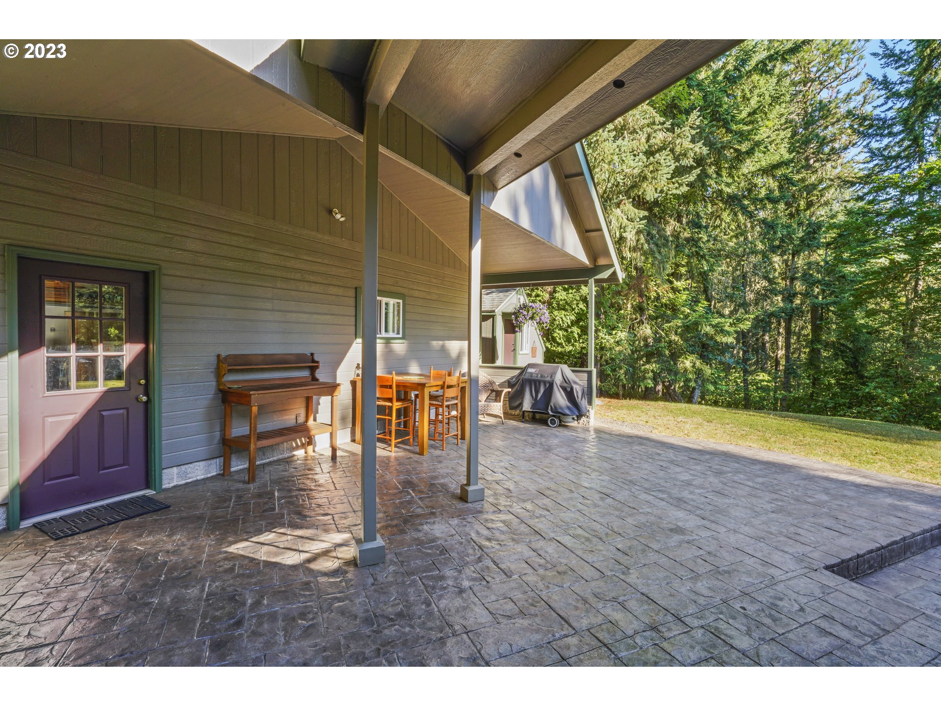 31861 Owl Road Eugene, OR 97405 - Photo 34 of 38 a view of a backyard with table and chair under an umbrella