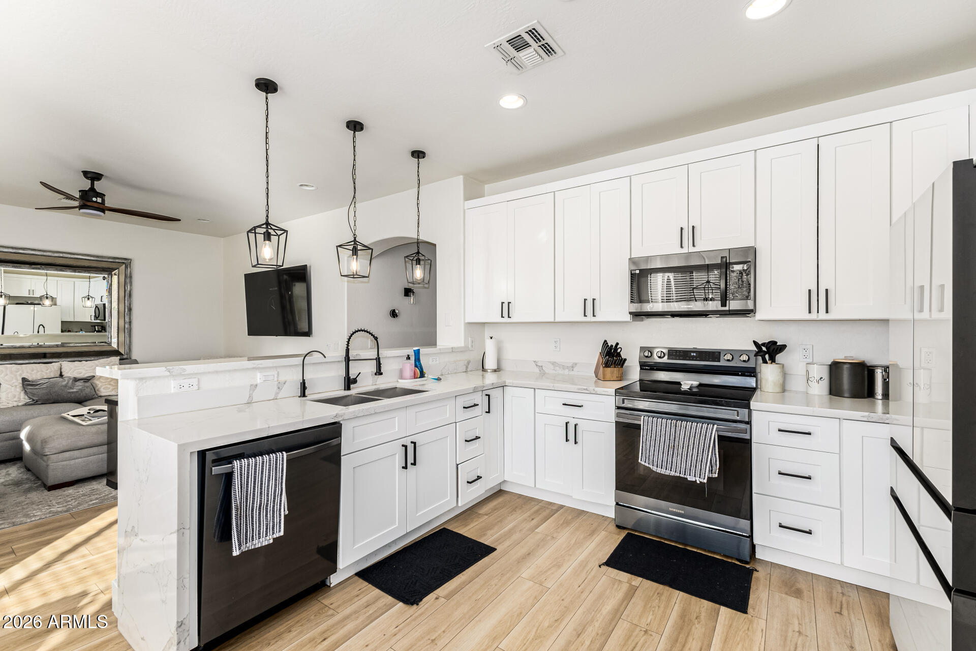 2707 West Lamar Road Phoenix, AZ 85017 - Photo 17 of 50 a kitchen with stainless steel appliances granite countertop a stove sink and cabinets