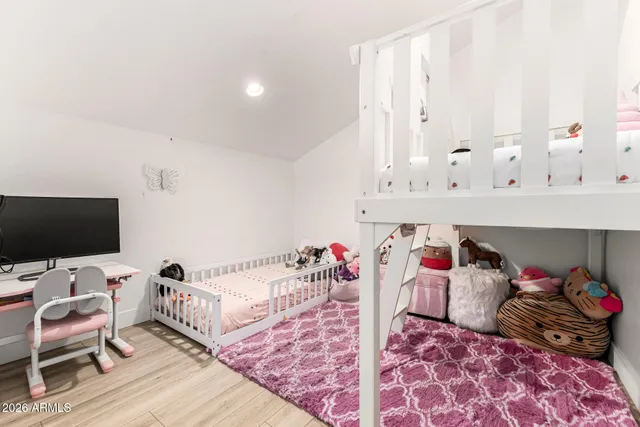 a bed room with a bed and a chair