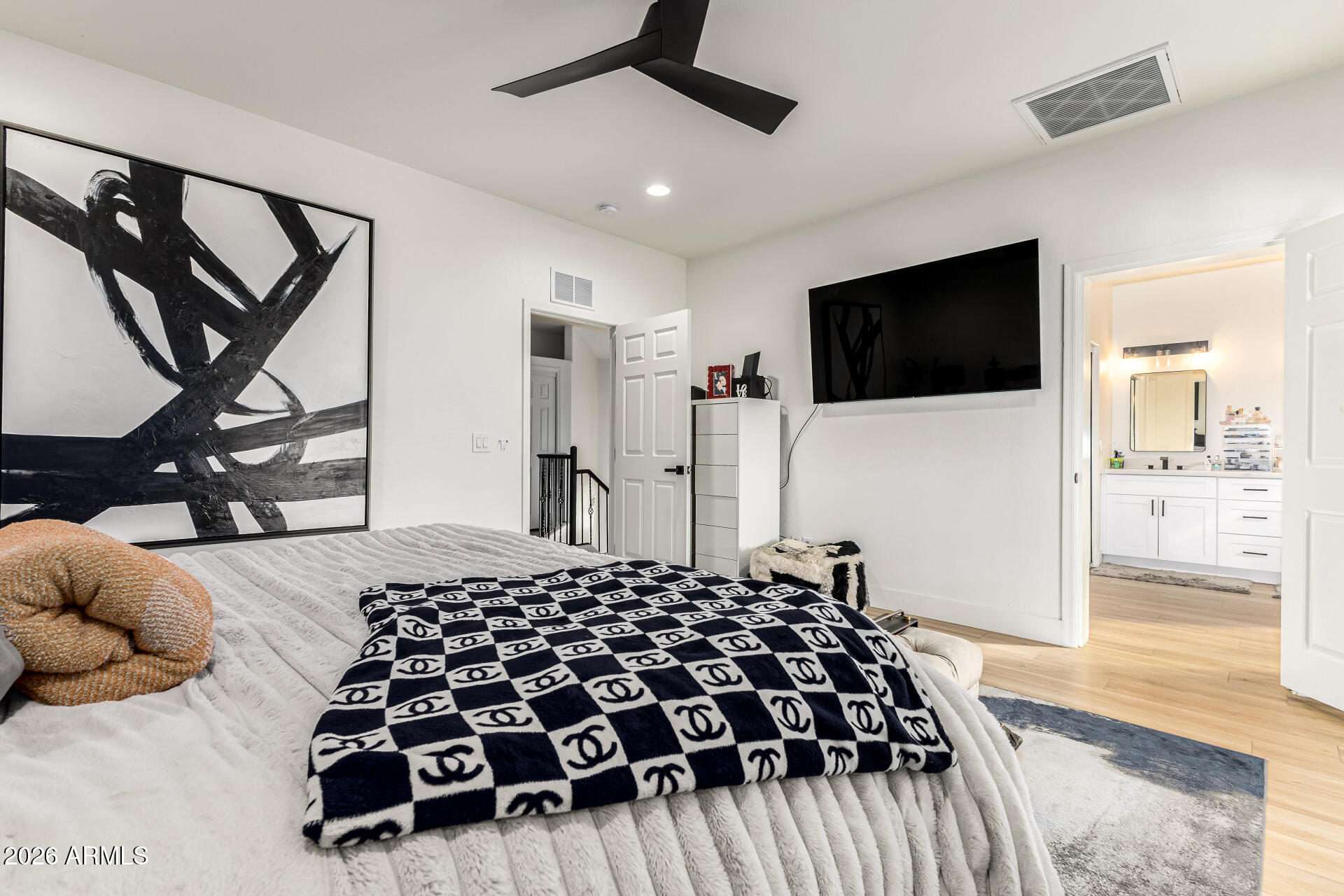 2707 West Lamar Road Phoenix, AZ 85017 - Photo 22 of 50 a bedroom with a bed and a flat tv screen on wall