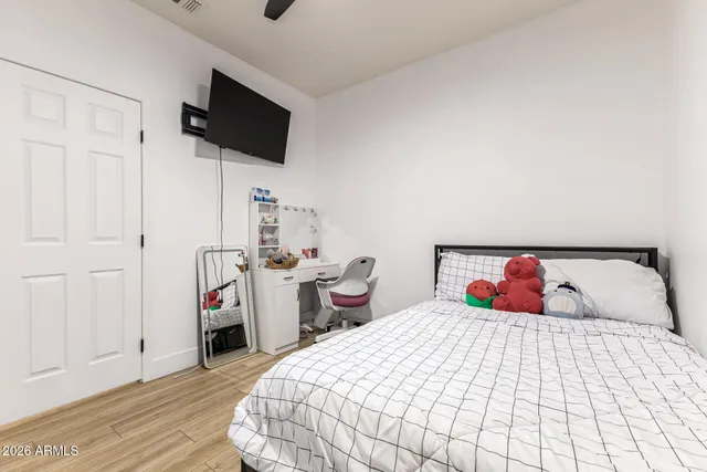 a bedroom with a bed and a flat screen tv