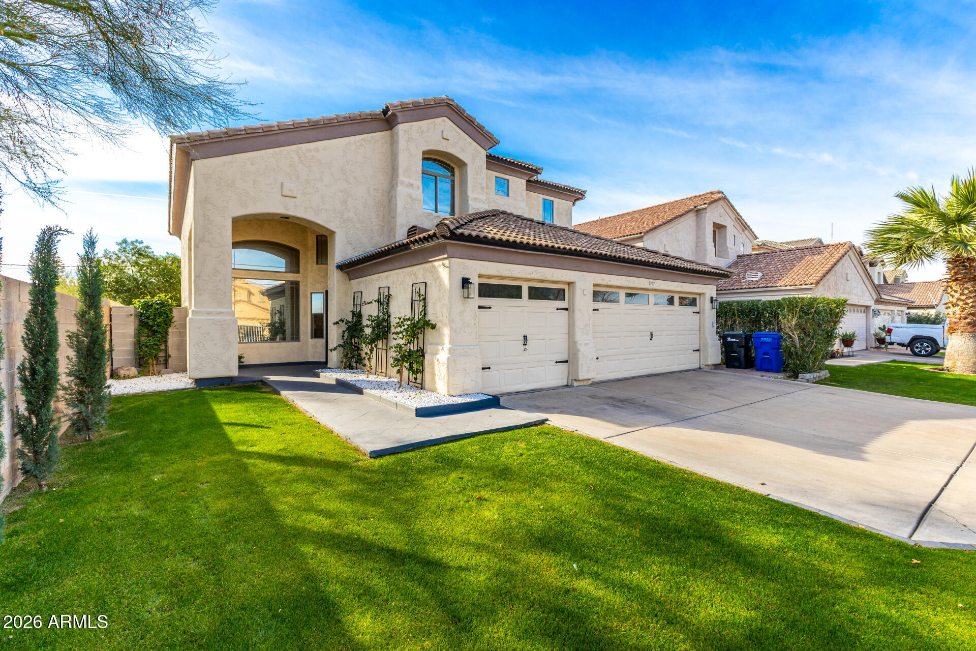 2707 West Lamar Road Phoenix, AZ 85017 - Photo 3 of 50 a front view of a house with a yard and garage