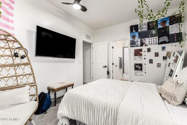 a bedroom with a bed and a flat screen tv
