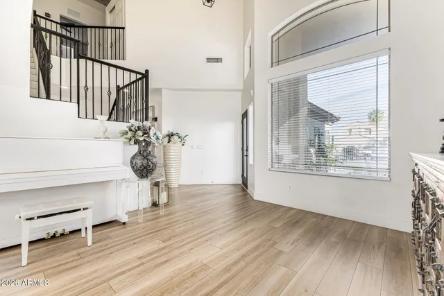 a view of a hallway with wooden floor and a living room