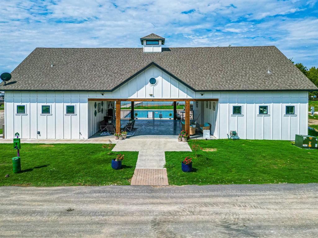 Lot 186 Peninsula Point Kerens, TX 75144 - Photo 22 of 28 a front view of a house with a yard and garage