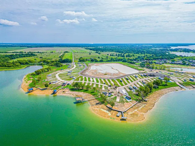 an aerial view of a swimming pool a yard and lake view