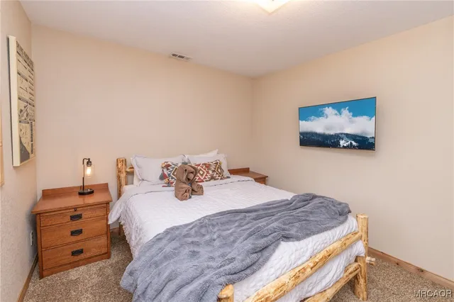 a bedroom with bed and window