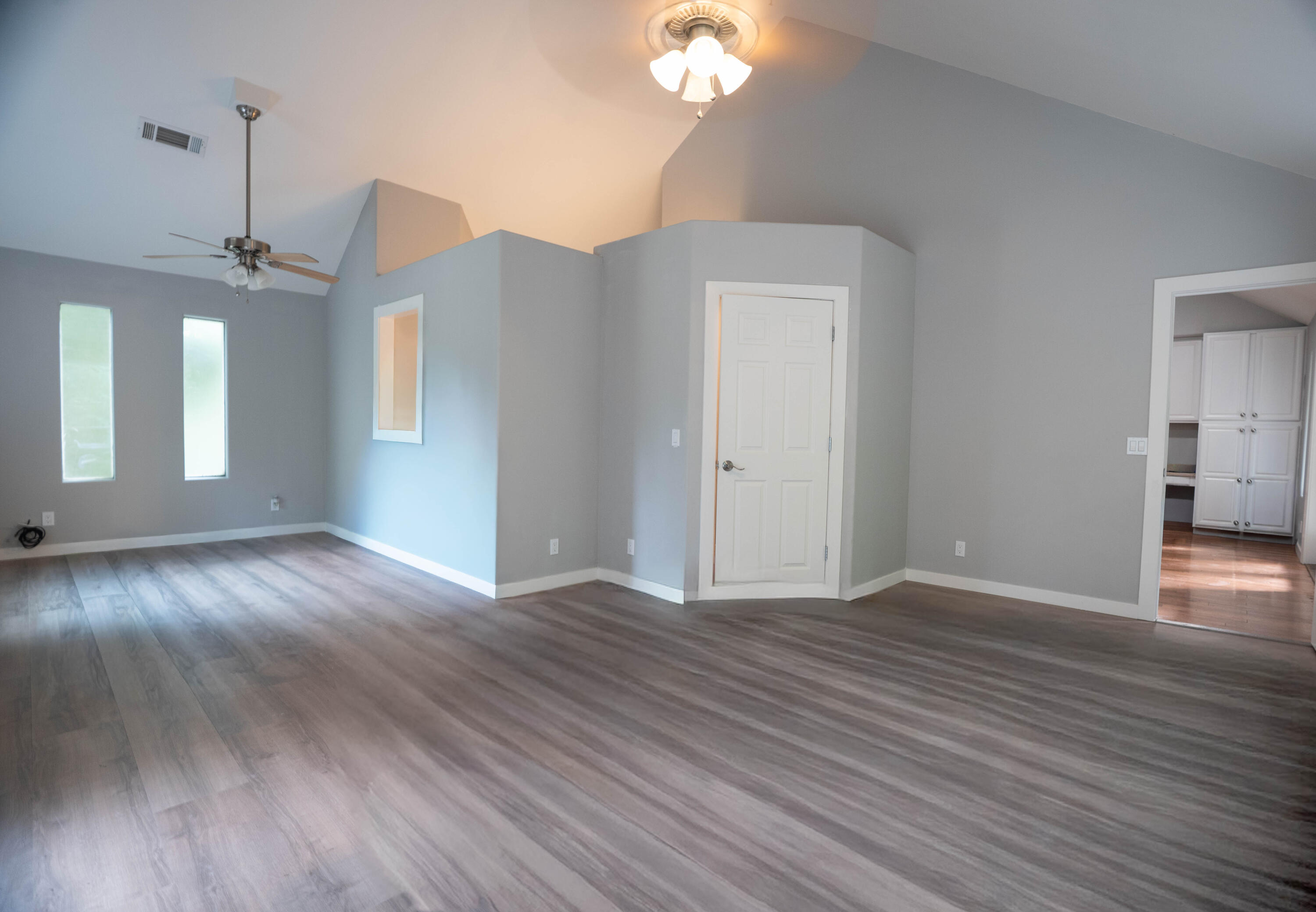 709 Pinewood Way Cave Junction, OR 97523 - Photo 10 of 24 a view of an empty room with wooden floor and a window