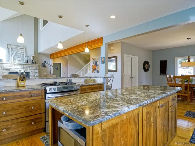 a kitchen with kitchen island counter top space a sink appliances and cabinets