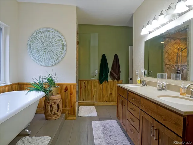 a bathroom with a tub sink and mirror