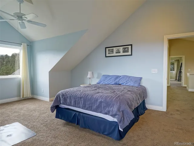 a spacious bedroom with a bed and window