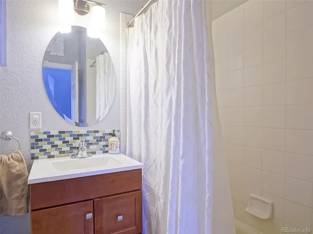 a bathroom with a sink vanity and a mirror