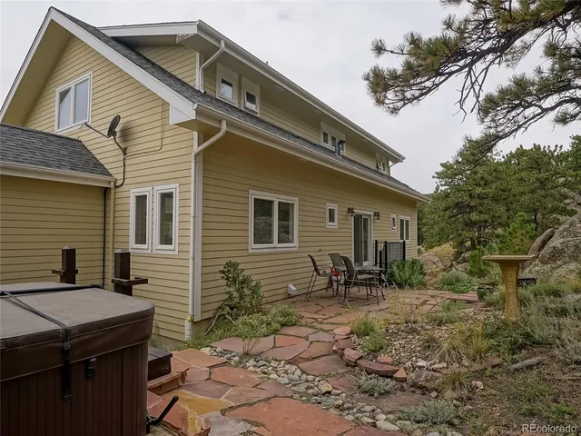 a backyard of a house with yard and outdoor seating