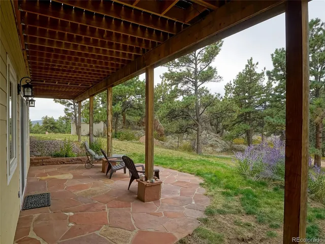 a view of a porch with chairs and backyard