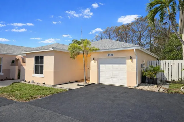 a view of a house with a yard and garage