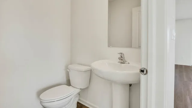 a white toilet sitting next to a white sink
