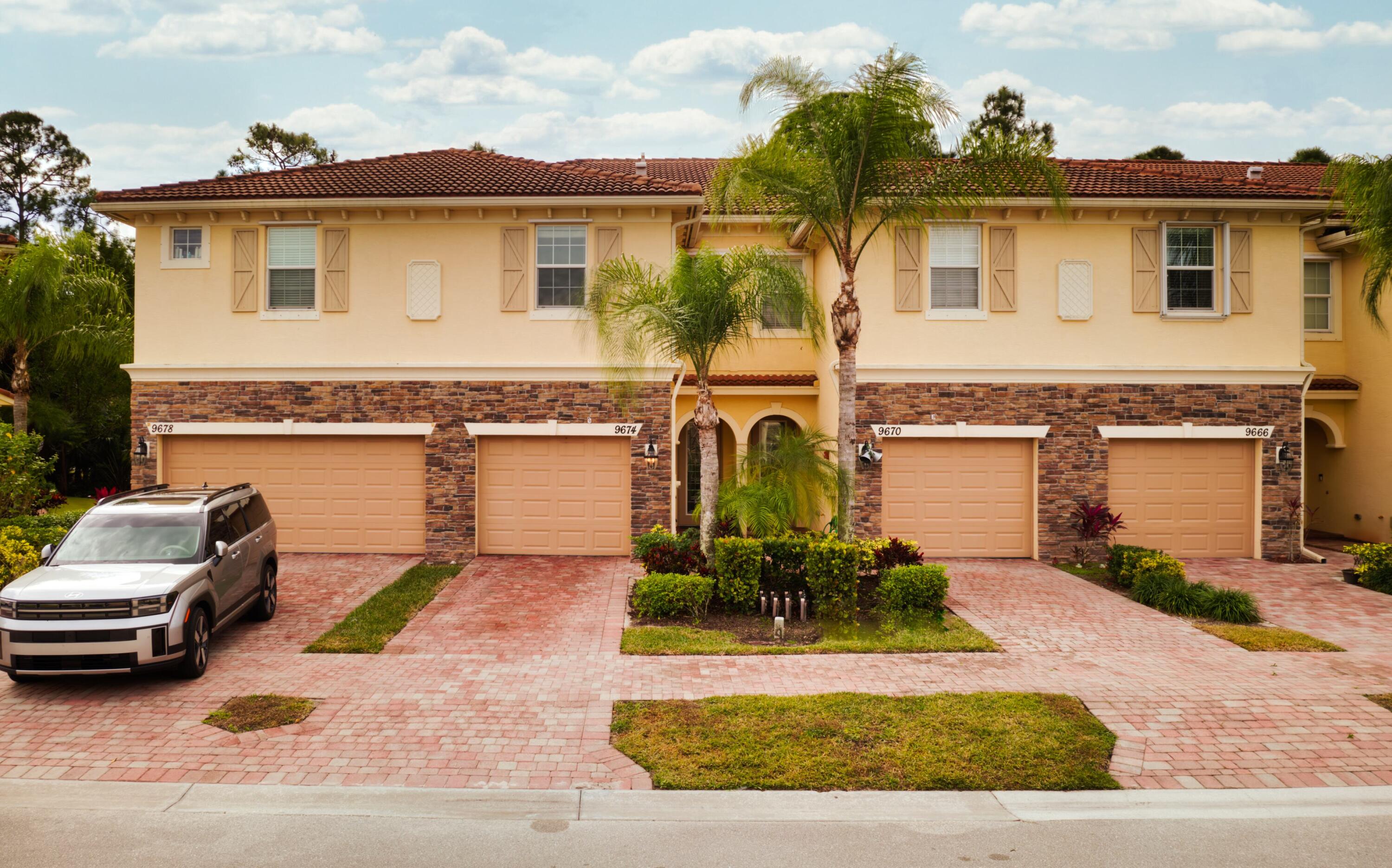 9674 Southwest Purple Martin Way Stuart, FL 34997 - Photo 1 of 21 front view of a house with a yard