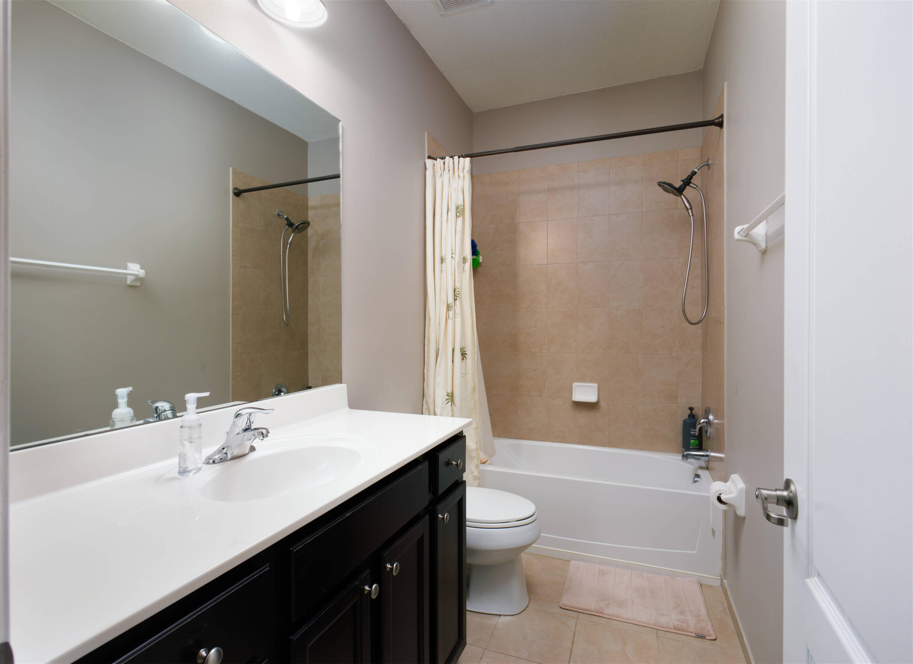 9674 Southwest Purple Martin Way Stuart, FL 34997 - Photo 11 of 21 a bathroom with a sink a toilet and shower