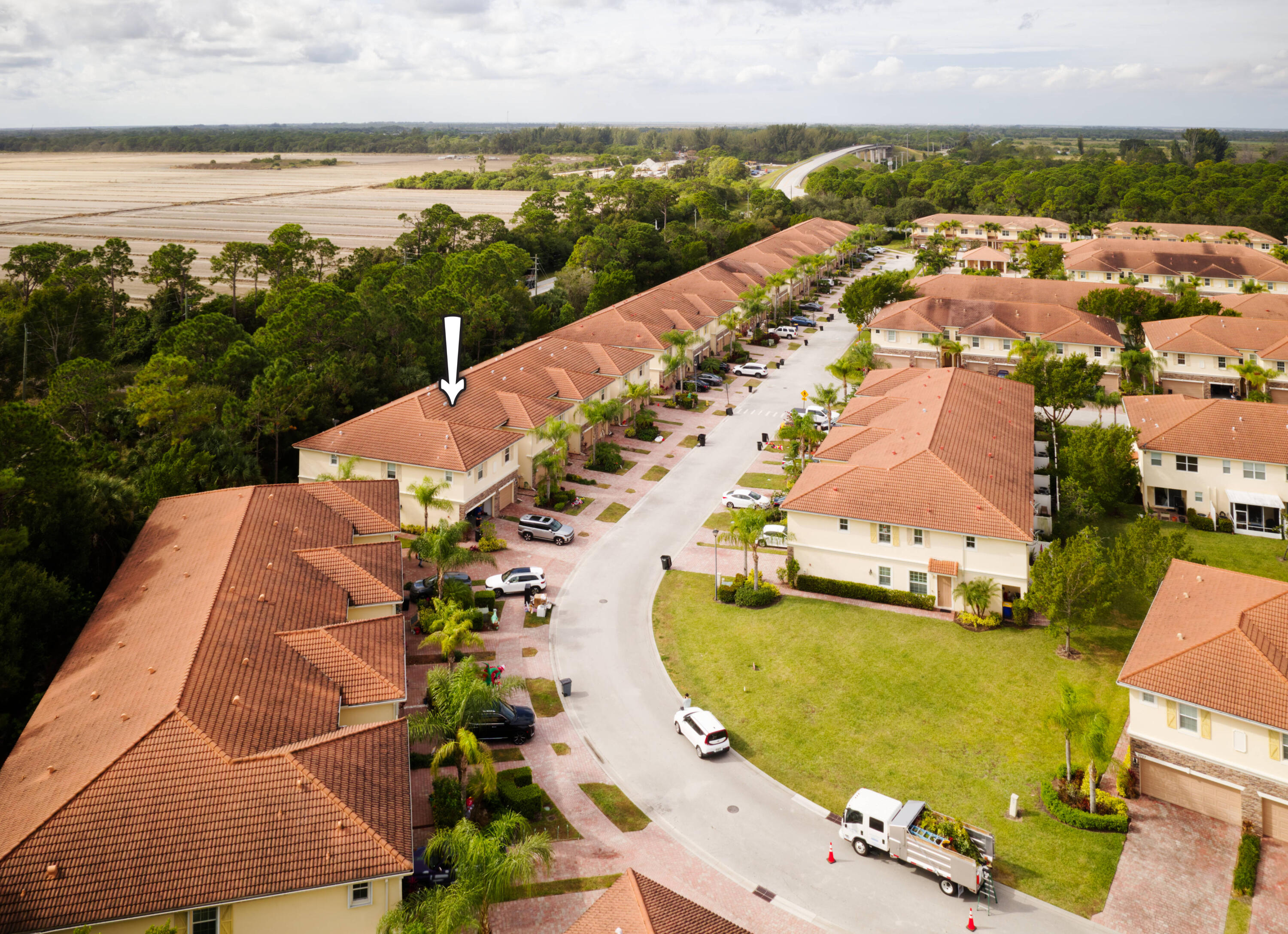 9674 Southwest Purple Martin Way Stuart, FL 34997 - Photo 16 of 21 an aerial view of a house with a swimming pool and outdoor seating